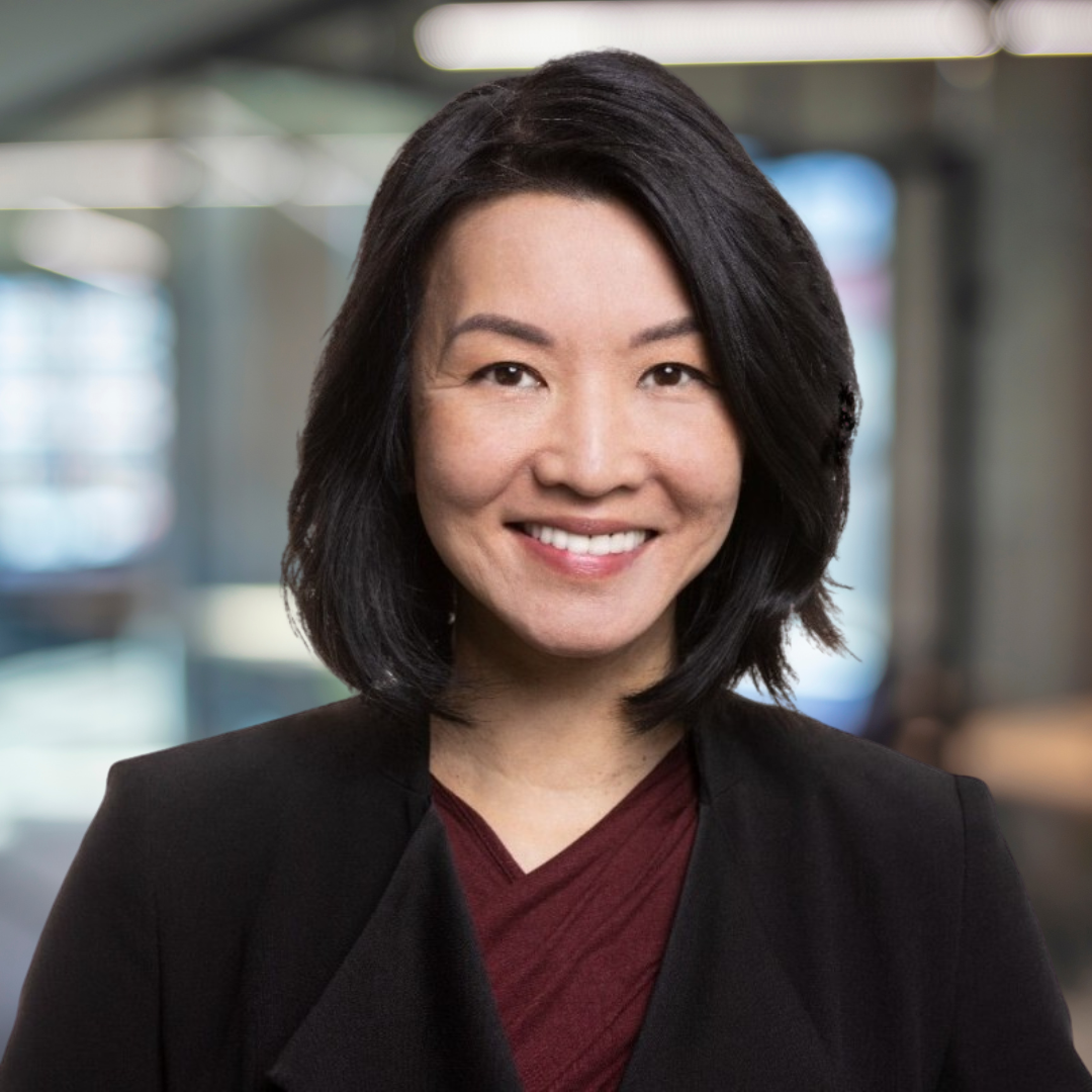 Headshot of Fan Pfeifer, a smiling woman with dark shoulder-length hair and a dark suit.